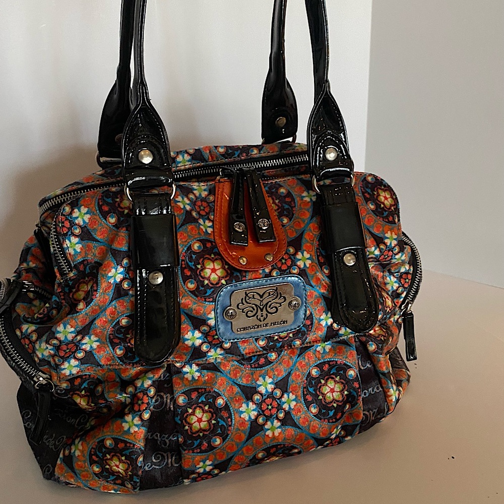 Large vibrant purse/bag with multiple zippers and snaps. Made in Mexico.
